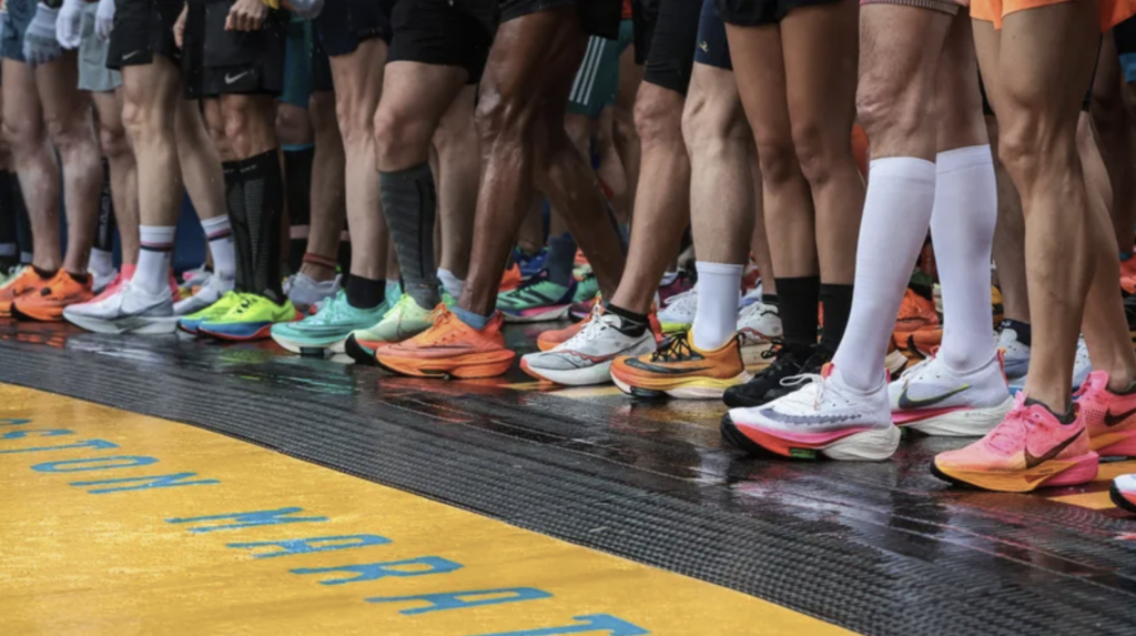 Runners' feet lined up at the start of a race, showcasing a variety of colorful athletic shoes on a track, symbolizing community participation in the Steps For Hope 5K Run and 1-Mile Walk in Brick, NJ.